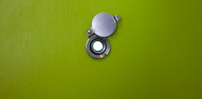door lens peephole on wooden texture