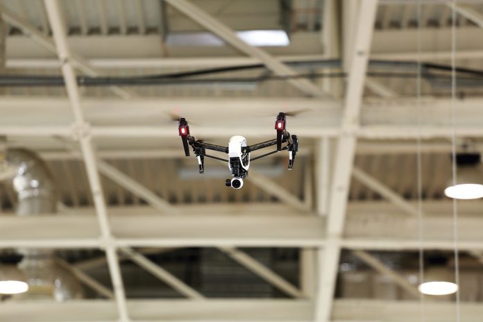 Modern dron flying with high resolution camera in the factory
