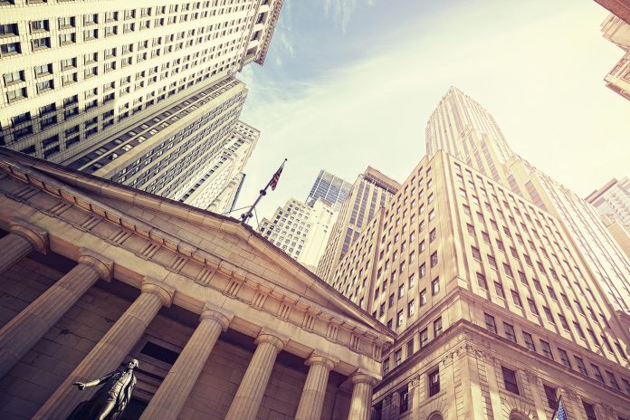 Vintage toned Wall Street at sunset, NYC.