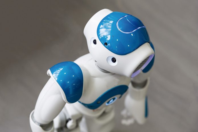 Small robot with human face and body. AI