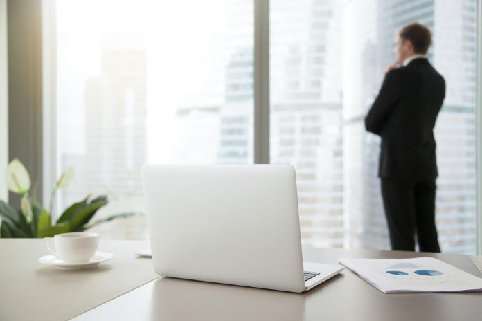 Confident business man contemplating in his office