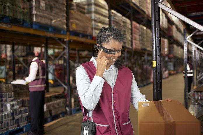 Woman using a barcode reader in a distribution warehouse