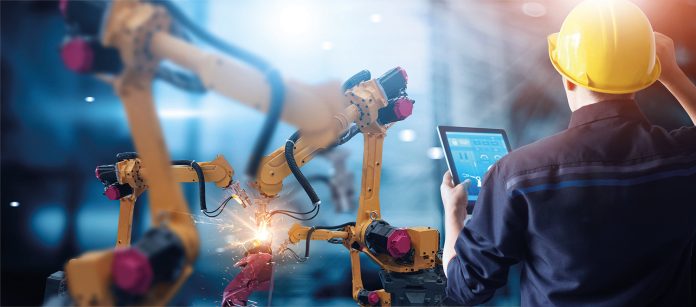 Engineer check and control welding robotics automatic arms machine in intelligent factory automotive industrial with monitoring system software. Digital manufacturing operation. Industry 4.0