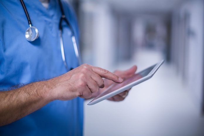 male-surgeon-using-digital-tablet-in-operation-room