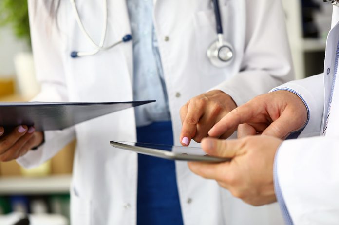 two-doctors-looking-in-tablet-pc-display